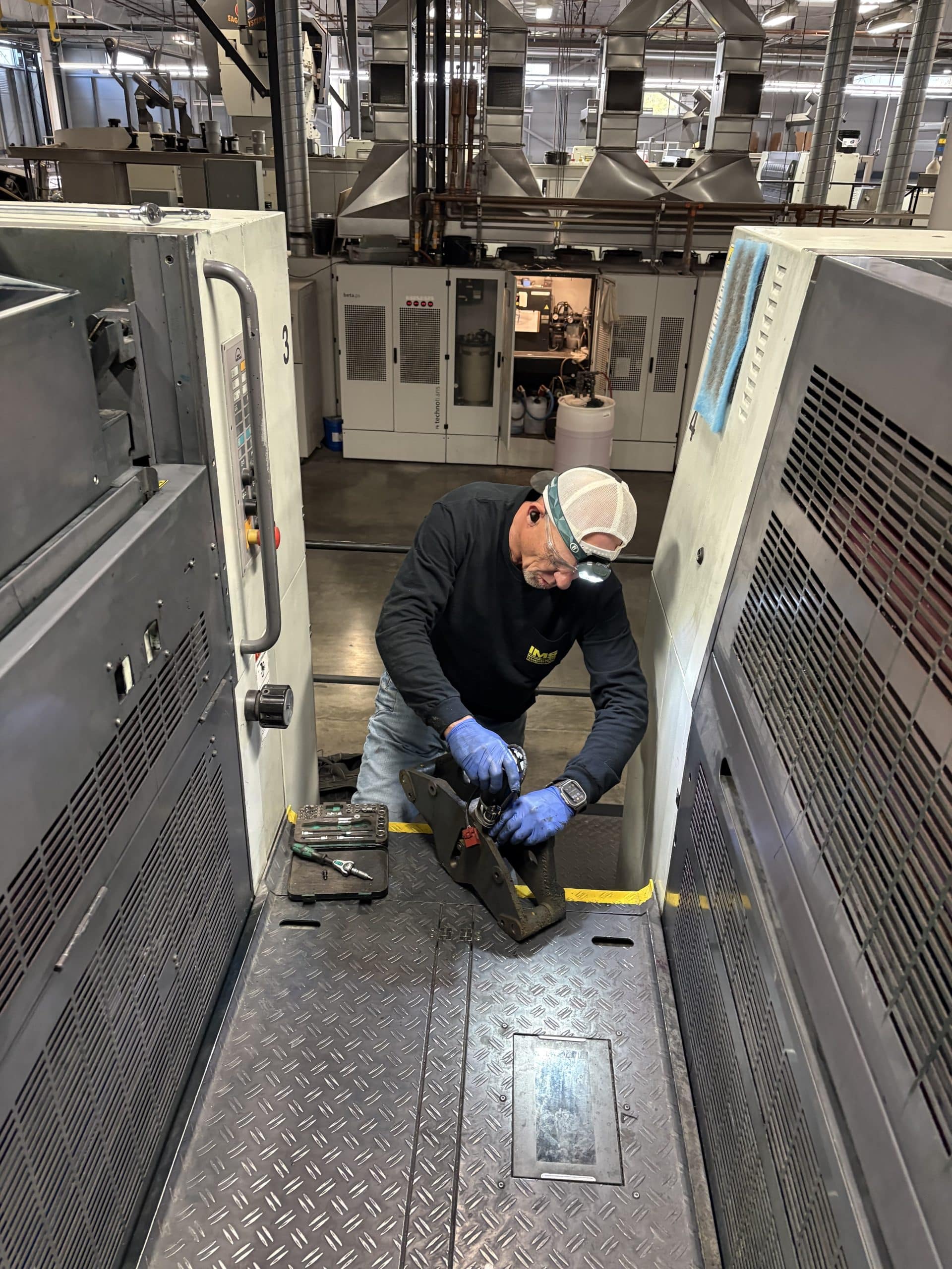 Millwright rebuilding worn components on production equipment
