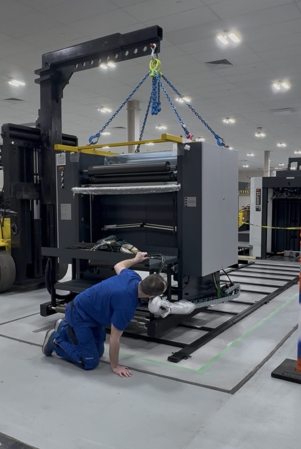 Millwright crew setting and aligning newly installed production machinery