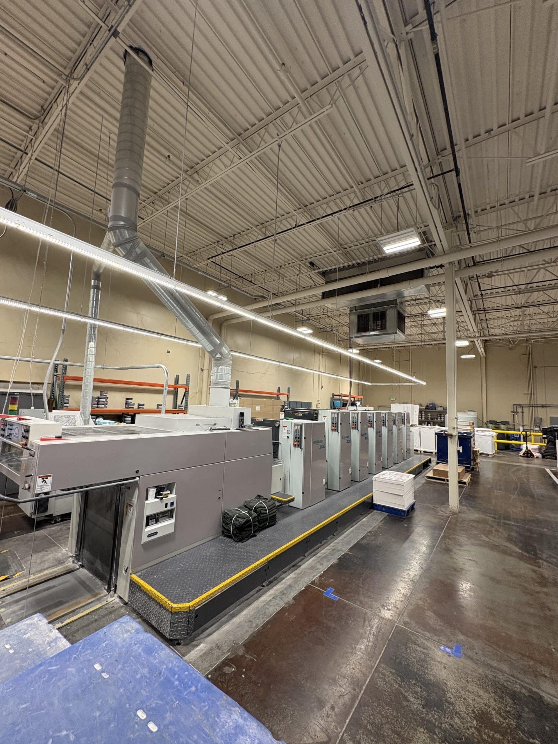 Technician performing industrial machinery repair on a plant floor